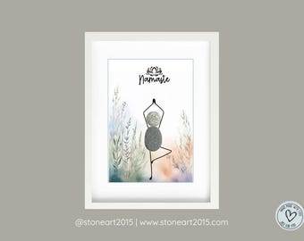 May include: Framed art print featuring a yoga pose made of stones. The word "Namaste" is written above the figure. The background has watercolor-style plants in shades of green, blue, and orange. The frame is white.