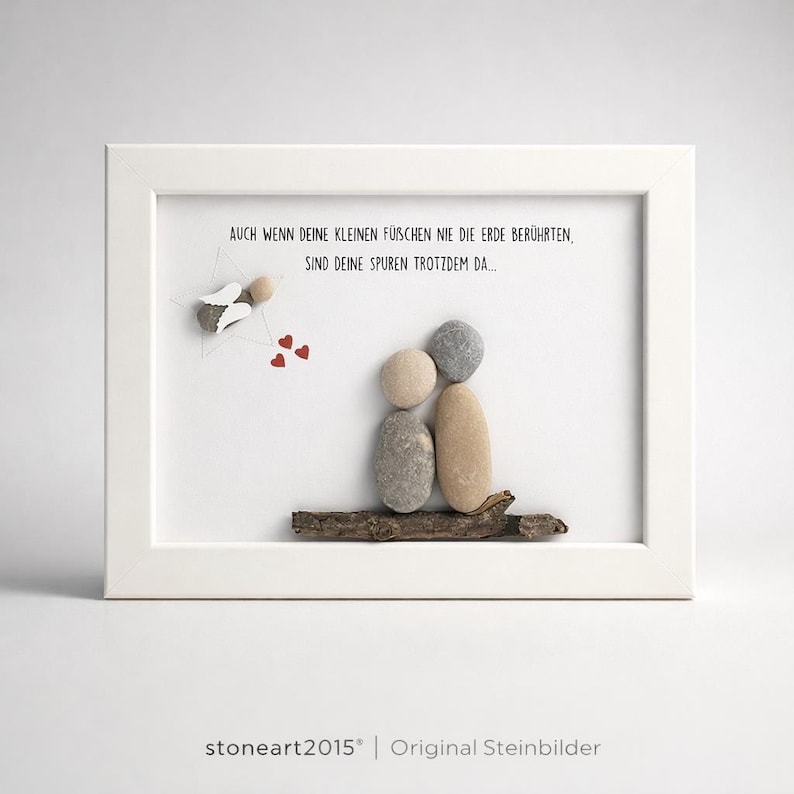 May include: A framed artwork featuring a family of stone figures on a wooden branch. The artwork includes a small angel figure and three red hearts. The text reads, "AUCH WENN DEINE KLEINEN F&Uuml;SCHEN NIE DIE ERDE BER&Uuml;HRTEN, SIND DEINE SPUREN TROTZDEM DA..."