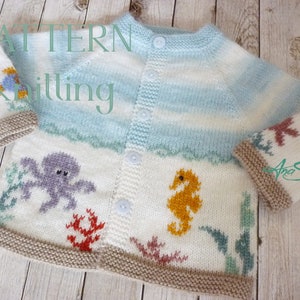 May include: A white knitted baby cardigan with a blue and white striped pattern. The cardigan features an octopus, a seahorse, and coral reef designs. The text "PATTERN knitting" is visible in the top left corner.
