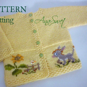 May include: A yellow knitted baby cardigan with a donkey, sunflower, and bird design. The cardigan has a button closure and is made with a fine knit stitch.