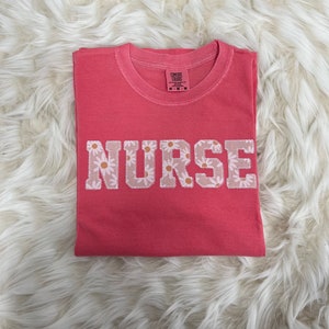 Comfort Colors Nurse Embroidered Daisy Applique Short Sleeve Shirt  | Simple RN Top, Gift for Healthcare, Personalized Nurse Coral Shirt