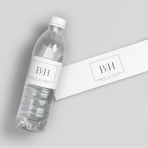 May include: White water bottle label with black text that reads "B|H Bryan & Hattie March 05, 2023".