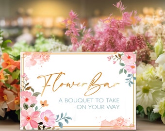May include: A white sign with a gold frame and floral design. The sign says "Flower Bar" and "A bouquet to take on your way".