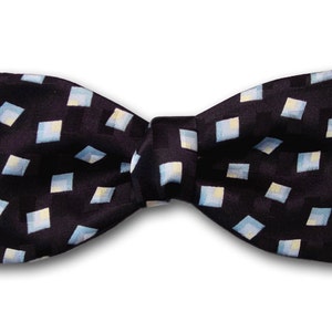 May include: A black bow tie with a white and light blue geometric pattern.