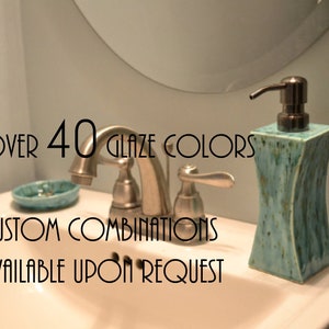 May include: A bathroom sink with a silver tap and a blue ceramic soap dispenser. The text "OVER 40 GLAZE COLORS CUSTOM COMBINATIONS AVAILABLE UPON REQUEST" is visible in the image.
