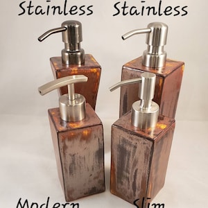 May include: Four stainless steel soap dispensers with a rustic, copper-toned finish. The dispensers have different pump styles and are labeled "Dark Stainless", "Stainless", "Modern Stainless", and "Slim Stainless".
