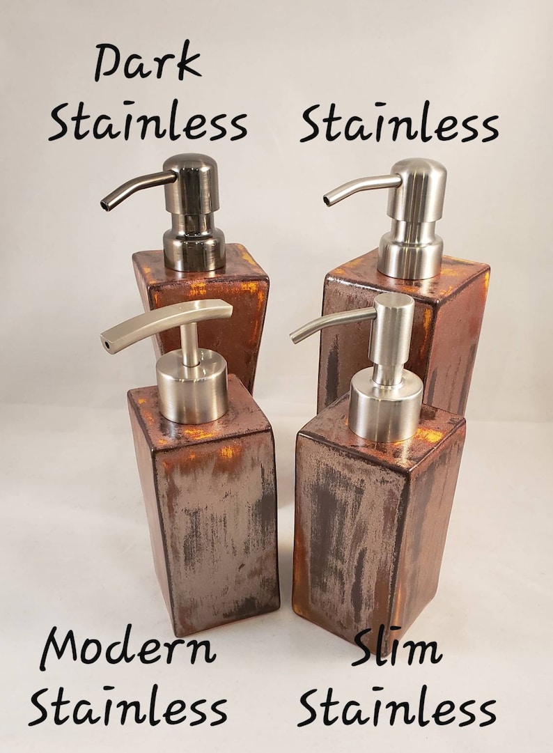 May include: Four stainless steel soap dispensers with a rustic, copper-toned finish. The dispensers have different pump styles and are labeled "Dark Stainless", "Stainless", "Modern Stainless", and "Slim Stainless".