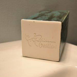 May include: A white ceramic rectangular box with a teal glaze and a signature that reads "Robin Creations".