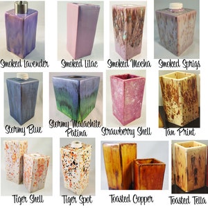 May include: A collection of 12 ceramic soap dispensers in various colors and patterns, including smoked lavender, stormy blue, tiger spot, and toasted copper.