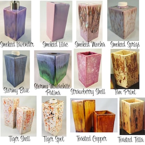 May include: A collection of 12 ceramic soap dispensers in various colors and patterns, including smoked lavender, stormy blue, tiger spot, and toasted copper.