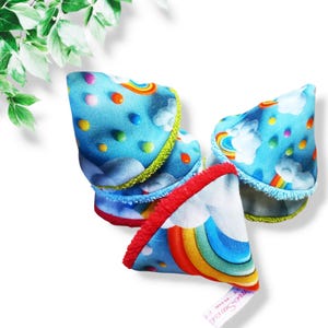 May include: Three blue fabric cones with a rainbow and cloud pattern. The cones have a green, blue, and red trim.
