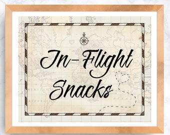 May include: A framed sign with a vintage world map background and the text "In-Flight Snacks" in a decorative font.