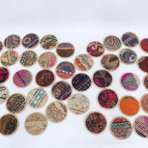 May include: A set of 30 round, colorful coasters made from repurposed vintage rugs. Each coaster features a unique pattern and design, adding a touch of bohemian charm to any home.