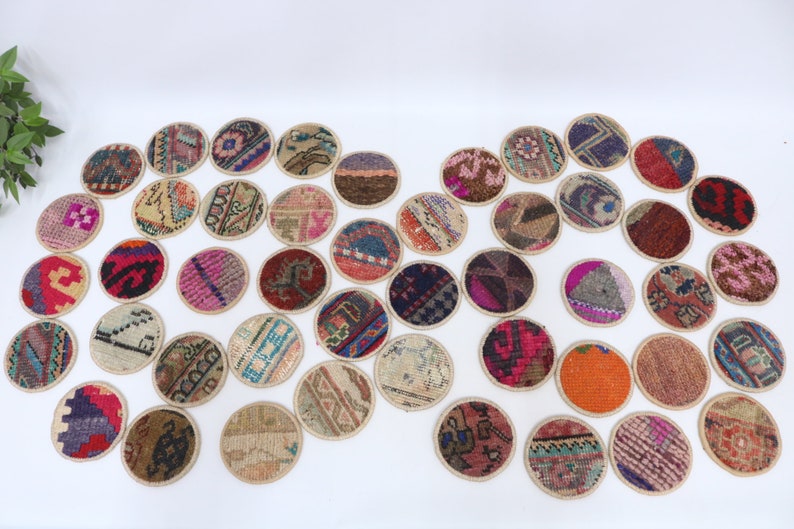 May include: A set of 30 round, colorful coasters made from repurposed vintage rugs. Each coaster features a unique pattern and design, adding a touch of bohemian charm to any home.