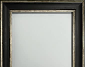 May include: Black picture frame with a silver inner border. The frame has a simple, classic design.