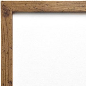 May include: A rustic brown wood picture frame with a white mount.