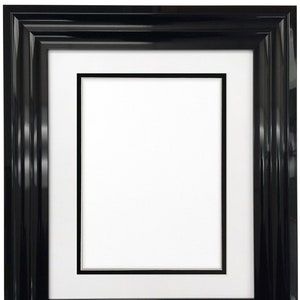 May include: A black picture frame with a white mount and a double black border. The frame has a glossy finish.