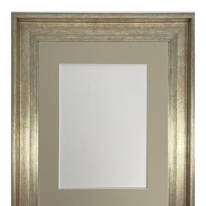 May include: A gold picture frame with a double mat. The outer mat is a light brown and the inner mat is a darker brown.