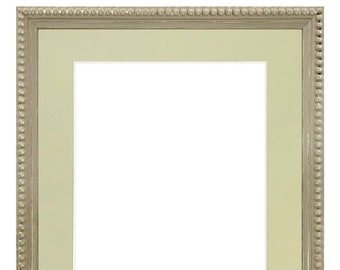 May include: Rectangular picture frame with a light green mat and a silver-colored beaded border. The frame has a neutral color palette, suitable for various art styles and decor.