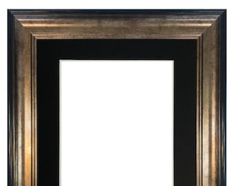 May include: A silver and black picture frame with a wide, ornate border. The frame has a black mat and is ready to display a photo or artwork.