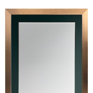 May include: A copper-coloured picture frame with a dark green mount. The frame is made of metal and has a brushed finish.