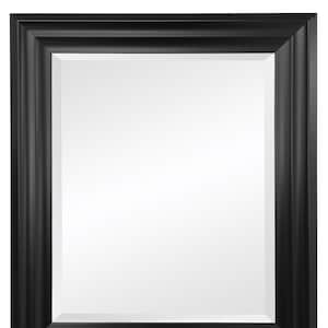 May include: A black framed mirror with a simple, rectangular design. The frame has a slightly raised edge and a smooth finish.