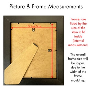 May include: A black picture frame with a brown mount and the text "Picture Size" printed on the mount. The frame is shown from the back, with the backing board removed, and the frame is measured with red lines.