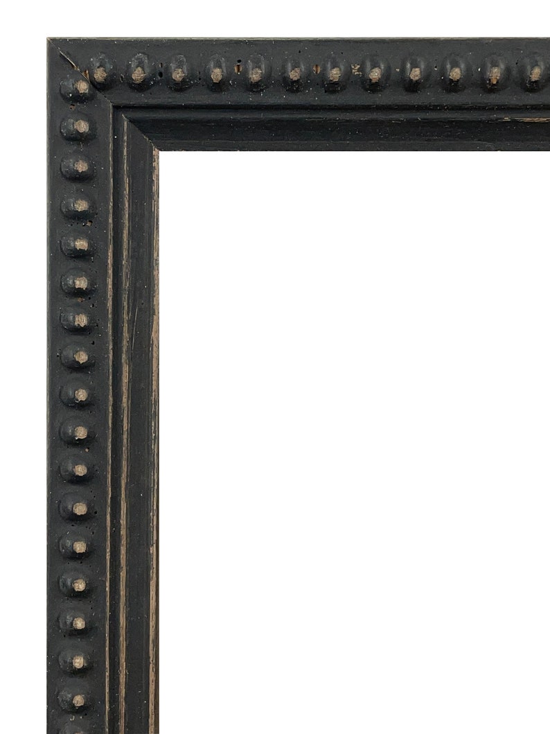 May include: Black picture frame with a decorative beaded edge. The frame is made of wood and has a distressed finish.