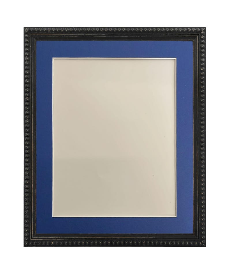 May include: A black picture frame with a blue mat. The frame has a beaded edge.