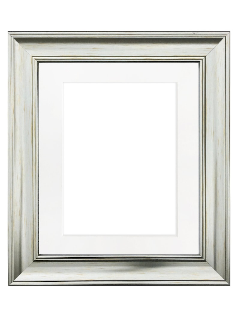 May include: A silver picture frame with a white mat. The frame has a distressed look and a slightly raised edge.