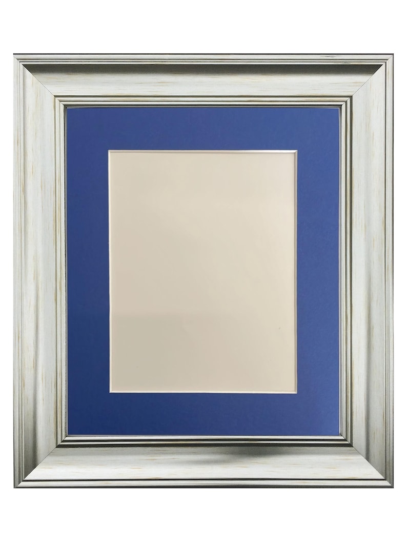 May include: A silver picture frame with a blue mount. The frame has a distressed wood-like finish.