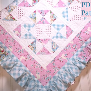May include: A quilt featuring a central block pattern with white, pink, and light blue fabric squares. The design includes floral, paisley, and gingham prints with a ruffled border. The text PDF Pattern is visible in the top right corner.