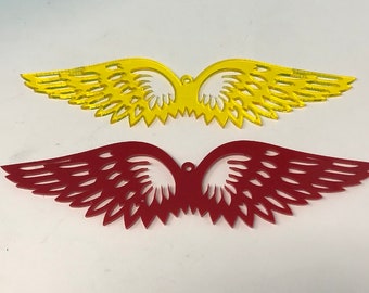May include: Two pairs of decorative wings, one pair is yellow and the other is red. The wings are made of a thin, translucent material and have a delicate, intricate design.