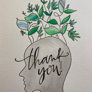 May include: Watercolor illustration of a gray silhouette of a head with green and blue leaves sprouting from the top. The words "thank you!" are written in black cursive script across the head.