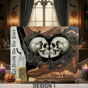 May include: A rectangular cutting board with a skull design. Two skulls face each other, surrounded by dark flowers. The board has the text "Til Death Do Us Part" and "Angela & Spartacus". The design is labeled "DESIGN 1".
