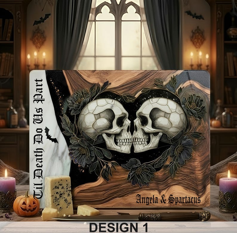 May include: A rectangular cutting board with a skull design. Two skulls face each other, surrounded by dark flowers. The board has the text "Til Death Do Us Part" and "Angela & Spartacus". The design is labeled "DESIGN 1".
