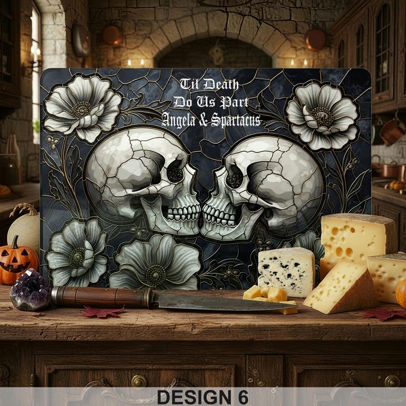 May include: A decorative cutting board featuring two skulls kissing, surrounded by white flowers and the text "Til Death Do Us Part Angela & Spartacus." The design is set against a dark blue background. "Design 6" is printed at the bottom.