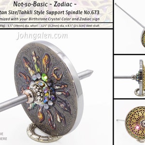 May include: A silver spinning wheel with a zodiac design and a steel shaft. The wheel is 3.8 cm in diameter and the shaft is 21.6 cm long. The wheel is decorated with a colourful zodiac design and a crystal.