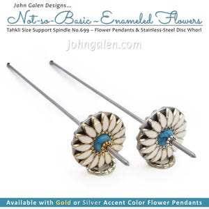 May include: Two Tahkli size support spindles with flower pendants. Each spindle has a silver shaft, a white and gold flower design, and a turquoise centre. The image text reads "Not-so-Basic Enameled Flowers."
