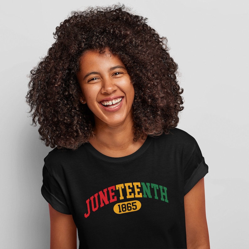 May include: A black t-shirt with a red, yellow, and green arc design that reads "Juneteenth 1865".