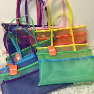 May include: A stack of colorful mesh tote bags with zippered closures. The bags are in various colors, including blue, green, purple, orange, yellow, and pink. The bags have the word "WALKER" printed on the front.