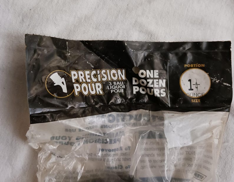 Pu&ograve; includere: Un sacchetto di plastica nero con la scritta "PRECISION POUR 3 BALL LIQUOR POUR ONE DOZEN POURS PORTION 1+ OUNCE SIZE" stampata su di esso. Il sacchetto contiene palline di plastica trasparenti.