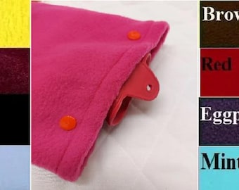 May include: A close-up of a hot pink fabric item with two orange buttons. The image also displays color swatches labeled Caramel, Yellow, Pink, Wine, Green, Black, Periwinkle, Sky, Brown, Red, Eggplant, Gray, Mint, and Orange.