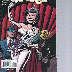 May include: Comic book cover featuring a woman dressed as Miss Europe, with a crown and sash, holding a bouquet of flowers. A man in a suit and fedora stands behind her. The comic book title is "The Spirit" with the text "Will Eisner's" above it.