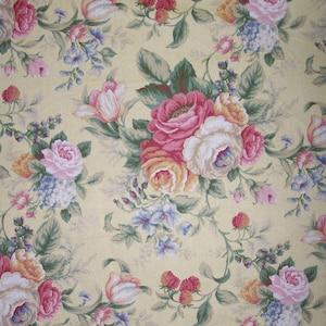 May include: A yellow floral fabric with a repeating pattern of pink, white, and yellow roses, tulips, and other flowers. The fabric has a vintage feel and would be perfect for crafting projects.