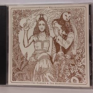 May include: CD case featuring sepia-toned artwork. The cover art depicts two figures, one raising a hand, the other with a hand to their face, and an owl. The text "Gillian Welch" and "The Harrow & The Harvest" are visible.