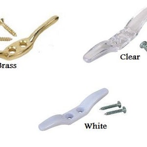 May include: Three cleat hooks with screws. The hooks are in brass, clear plastic, and white plastic.