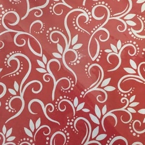 May include: Red background with a white swirl pattern. The pattern is made up of leaves, swirls, and dots.