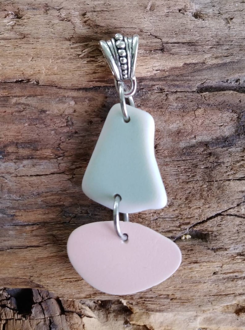 Pink and most green Lake Erie beach pottery boat pendant.