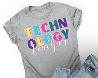 May include: A grey t-shirt with the text "TECHNOLOGY teacher" in colourful, outlined letters. The letters are in different colours, including yellow, pink, blue, and green.